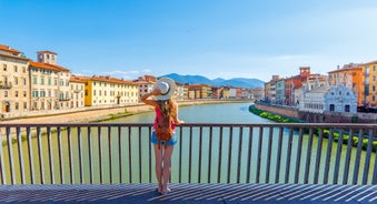 Photo of aerial view of Verona historical city centre, Ponte Pietra bridge across Adige river, Verona Cathedral, Duomo di Verona, red tiled roofs, Veneto Region, Italy.