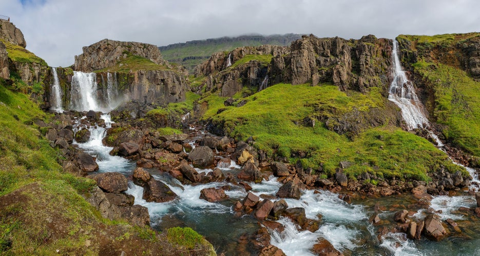 Seydisfjordur, Iceland,  Vestdalsfossar hike on Bjolfur mountain in Seydisfjord, Iceland. Beautiful waterfalls on the mountain near Seydisfjordur, Iceland in the summer.