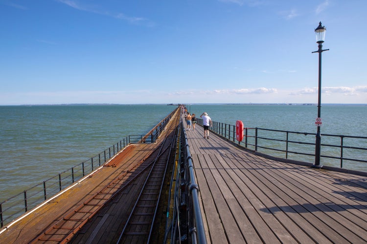 Photo of view along Southend Pier in Southend-on-Sea in Essex, UK. Measuring over 1.3 miles long, it is the longest pleasure pier in the world.