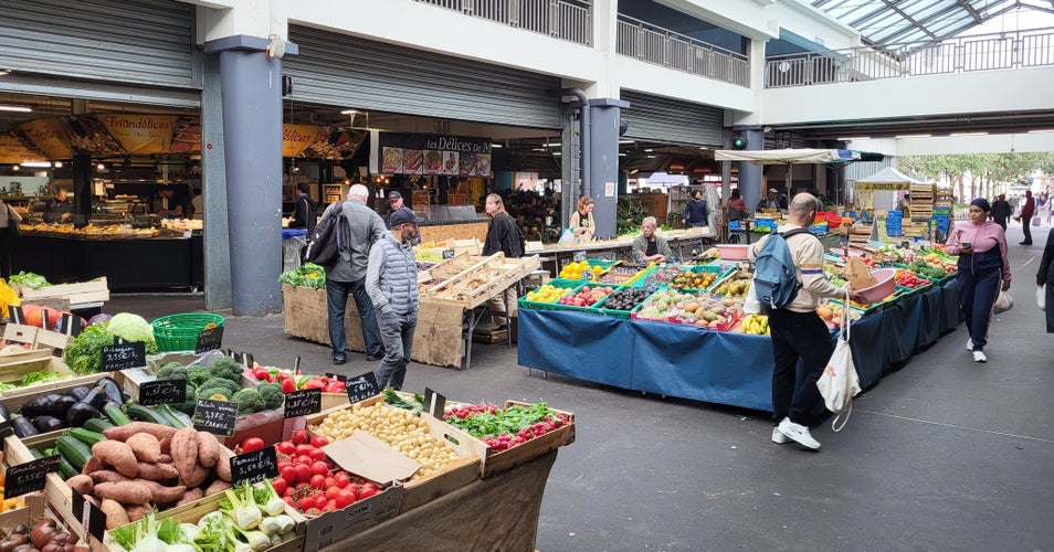 Fresh produce stalls and shoppers inside Marché des Capucins, Bordeaux’s main food market, on a busy morning..jpg