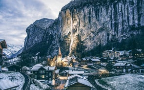 Photo of beautiful autumn view of Lauterbrunnen valley with gorgeous Staubbach waterfall and Swiss Alps at sunset time, Switzerland.