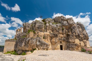 Photo of panoramic view of the ancient town of Matera (Sassi di Matera), European Capital of Culture 2019, in beautiful golden morning light with blue sky and clouds, Basilicata, southern Italy.