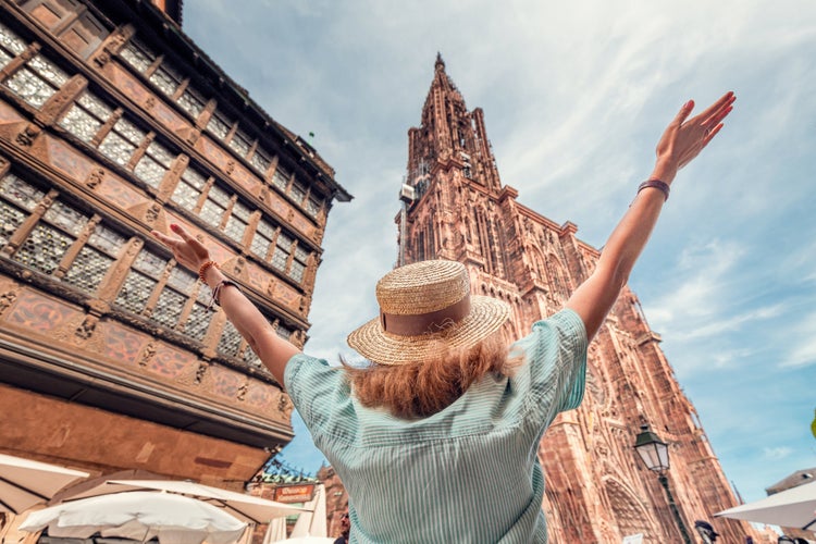 Photo of tourist in Strasbourg, France. Looking to famous Notre Dame Cathedral.