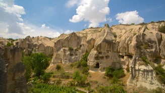 Hot air balloons flying over Uchisar Castle. Cappadocia. Nevsehir Province. Turkey.