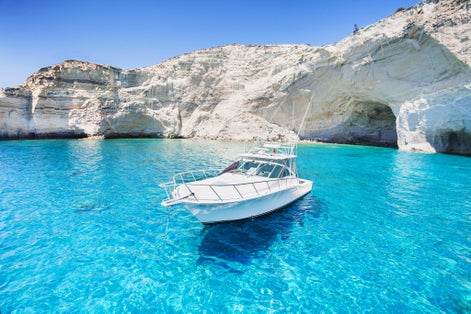 Photo of sailboat in a beautiful bay, Milos island, Greece.