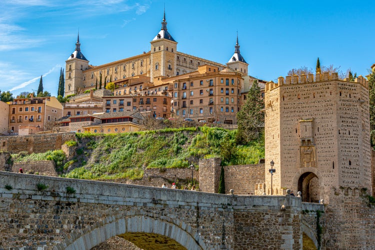 Panoramic view of Alcazar and Alcantara Bridge in the city Toledo, Spain