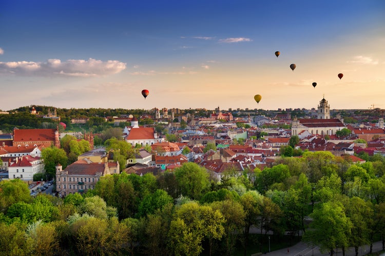 Photo of beautiful summer panorama of Vilnius old town with colorful hot air balloons in the sky, Lithuania.