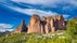 photo of a scenic view of the famous rock formations of Mallos de Riglos under wispy sky background in Las Peñas de Riglos, Spain.