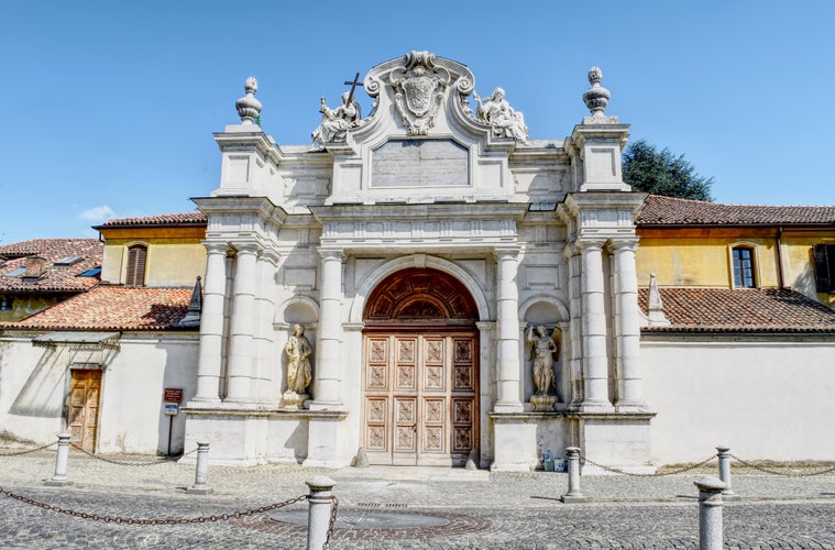 Photo of main entrance of the white Certosa of Collegno, Italy.