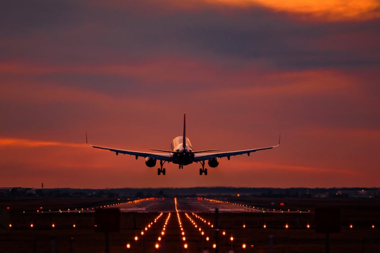 photo of view of Airplane landing at sunset on otopeni airport.