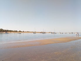 Photo of aerial view of pier fishing boats in the village Cabanas de Tavira, Portugal.