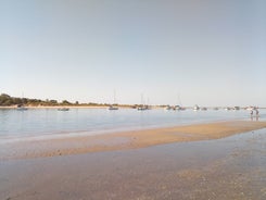 Photo of aerial cityscape of beautiful Tavira with roman bridge over Gilao river in the evening, Algarve, Portugal.