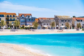 Photo of panorama and landscape of Makarska resort and its harbour with boats and blue sea water, Croatia.