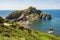 photo of green Rocky Mountains, coastline scenery, morning view of San Juan de Gaztelugatxe, Spain.