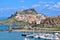 a view of the 'Castello dei Doria', a medieval fortress towering over the quaint old town of Castelsardo, Sardinia, and its marina below