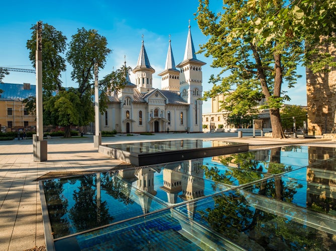 Central square of Baia Mare, the capital of Maramures County, Romania with Saint Nicholas Orthodox Church reflected in the glass