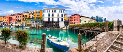 Famous buildings, gondolas and monuments by the Rialto Bridge of Venice on the Grand Canal, Italy.