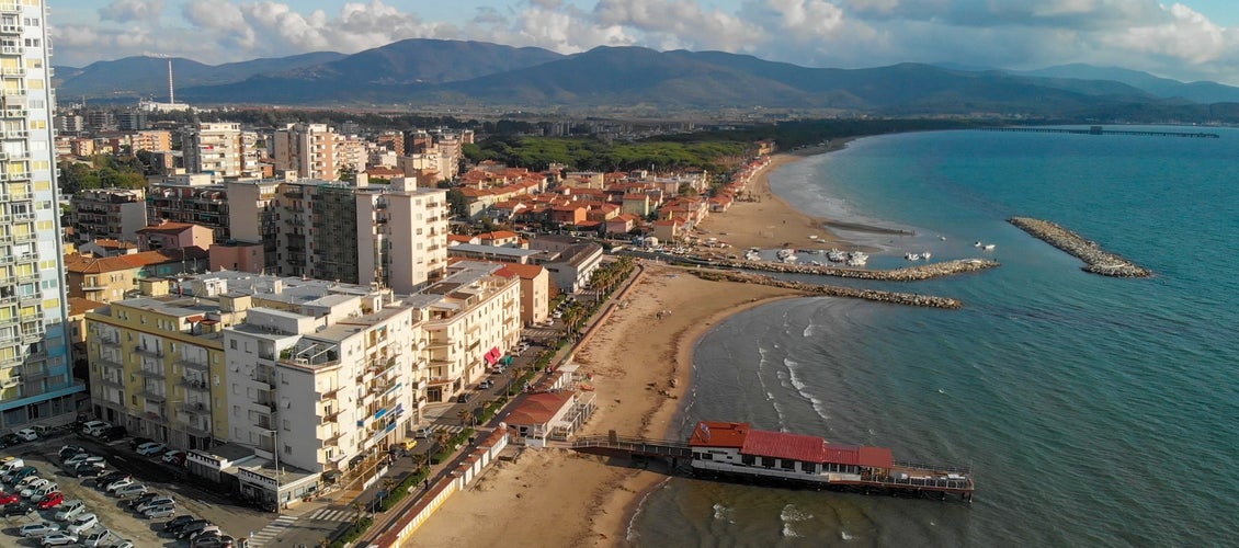 Panoramic aerial view of Follonica, Italy. Coastline of Tuscany with town and ocean.