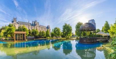 Photo of Water fountain in central square in Iasi town, Cultural Palace in background, Moldavia, Romania.