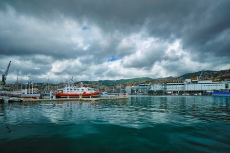 PHOTO OF Old Port Porto Antico of Genoa (Genova) with yachts and boats with aquarium biosphere building under stormy sky. Genoa, Italy .