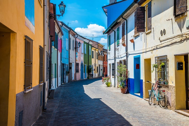 photo of view of A view down a colourful street in the village area of San Giuliano in Rimini, Italy in summertime