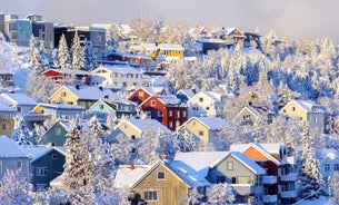 Photo of houses, bridge and panorama of Norwegian city Tromso beyond the Arctic circle from mountain in Norwegian fjords.