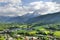 photo of Elevated, scenic view of the town of Bischofswiesen, Bavaria, Germany. The Watzmann Mountain, part of the Bavarian Alps rises into a majestic skyline. A green, spring landscape set in the valley.