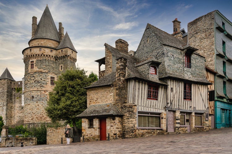 photo of view of wooden houses and the tower of the fortification of Vitré in France.