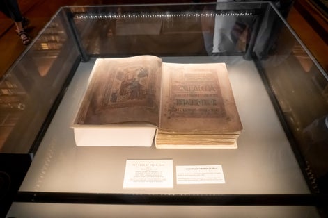 Photo of Book of Kells replica on display in the Long Room Library at Trinity College, Dublin, Ireland.