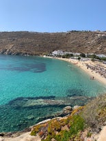 Photo of panoramic aerial view of the popular Platis Gialos beach on the Greek island of Mykonos with turquoise sea, Greece.