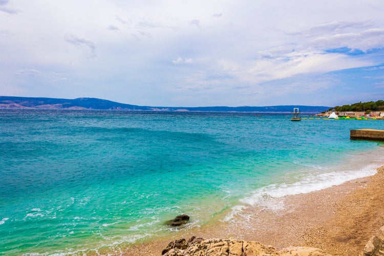 Wonderful sand and rocky beach and promenade in Novi Vinodolski Croatia.