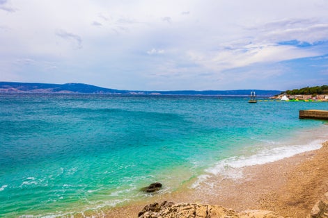 Wonderful sand and rocky beach and promenade in Novi Vinodolski Croatia.