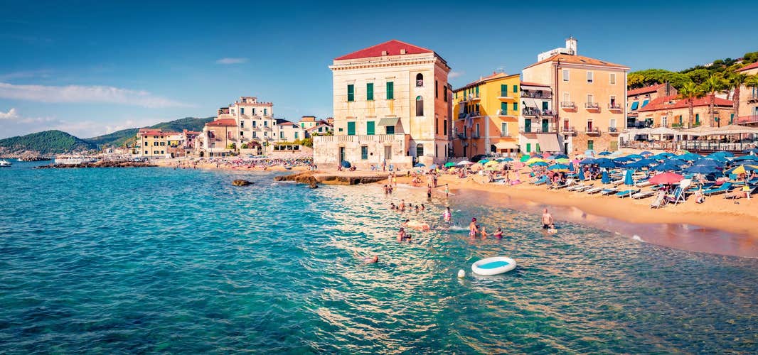 Hot summer day on Santa Maria di Castellabate puclic beach. Picturesque outdoor scene of Italy, Europe. Vacation concept background.