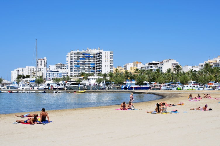 Sunbathers at Arenal Beach in San Antonio Ibiza Island, Spain.jpg