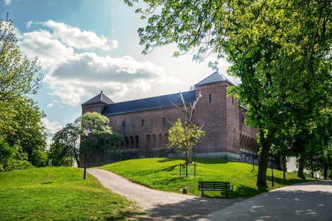 photo of old Vanadislunden reservoir (brick building on hill) in sunny fantastic may day in park Vanadislunden of Stockholm, Sweden.