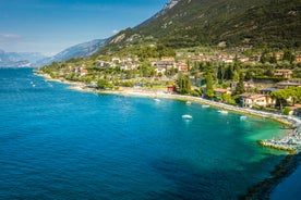 Photo of aerial view of superb Malcesine Mediterranean cityscape with colorful buildings and boats, yachts in the bay, lake Garda, Italy.