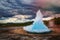 photo of Famous Strokkur fountain geyser hot blue water eruption with cloud sky and surrounding Icelandic landscape, Iceland.