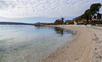 photo of a beautiful panoramic view of Kastel Luksic harbor and landmarks summer view, Split region of Dalmatia, Croatia.