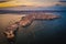 Siracusa, Ortigia Island from the air at sunset, Sicily, Italy. Isola di Ortigia, coast of Ortigia island at city of Syracuse, Sicily, Italy. Aerial view. June 2023