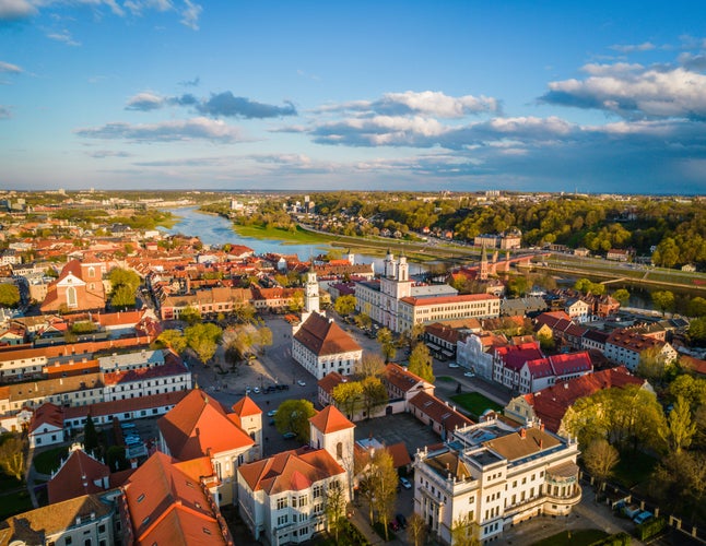 Photo of aerial view of a sunny day in Kaunas city town hall square with red roof tops, Lithuania.