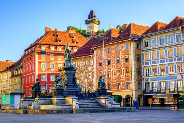 Photo of facades and the clock tower in the old town of Graz, Austria.