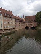 Photo of scenic summer view of the German traditional medieval half-timbered Old Town architecture and bridge over Pegnitz river in Nuremberg, Germany.