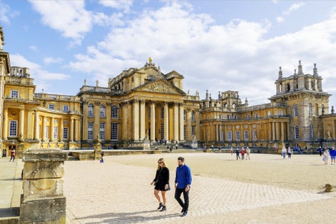 A view of Blenheim Palace and its front courtyard during a clear sky sunny day.