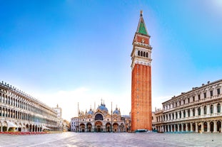 Famous buildings, gondolas and monuments by the Rialto Bridge of Venice on the Grand Canal, Italy.