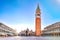 photo of sunrise in san marco square with campanile and san marco's basilica. Panorama of the main square of the old town. Venice, Italy.