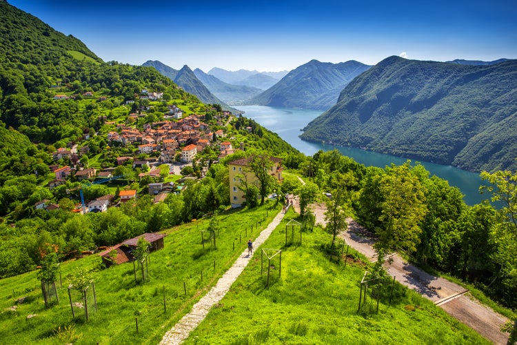 Photo of aerial view to Lugano city, Lugano lake and Monte San Salvatore from Monte Bre, Ticino, Switzerland.