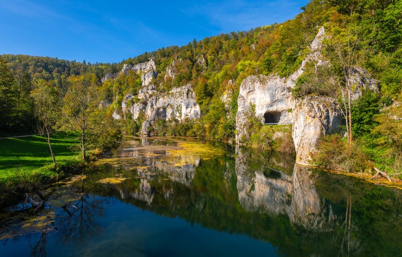 Panoramic view of Danube river valley near Sigmaringen, Germany. Limestone cliffs, colorful foliage and clear water reflecting idyllic scenery. Road between Dietfurt and Gutenstein with tunnels.