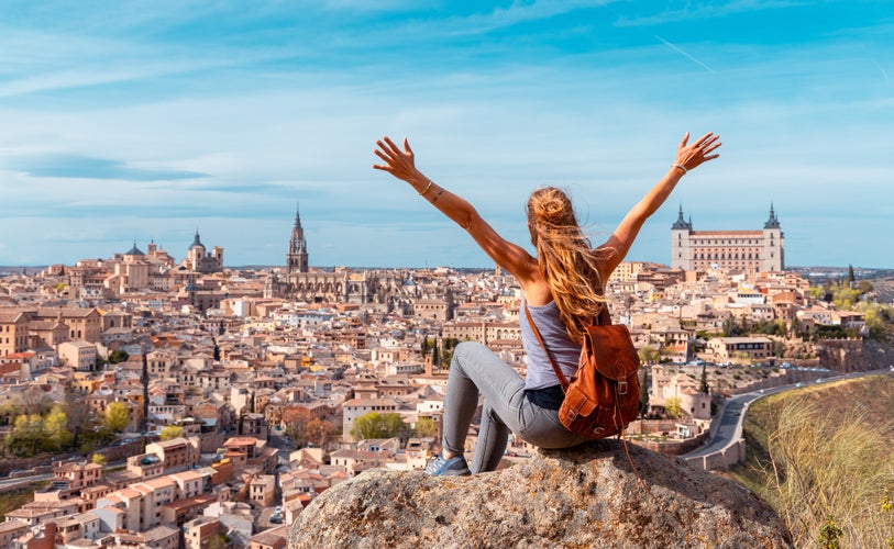 photo of view of Woman tourist enjoying panoramic view of Toledo city- Castilla la Mancha, Spain