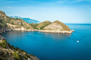 Photo of aerial view Nerano village, Infrastructure of a small town in the south of Italy, old houses, tight construction, mountain and sea in the background.