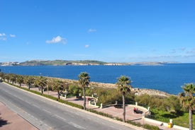 Photo of Seaside cliffs, colourful houses and streets of Qawra town in St. Paul's Bay area in the Northern Region, Malta.